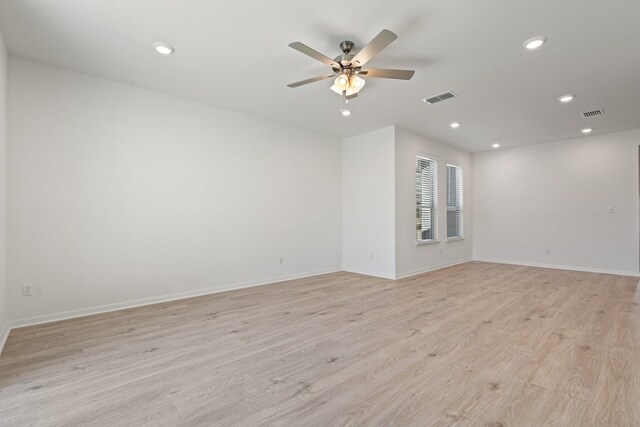 empty room with ceiling fan and light wood-type flooring