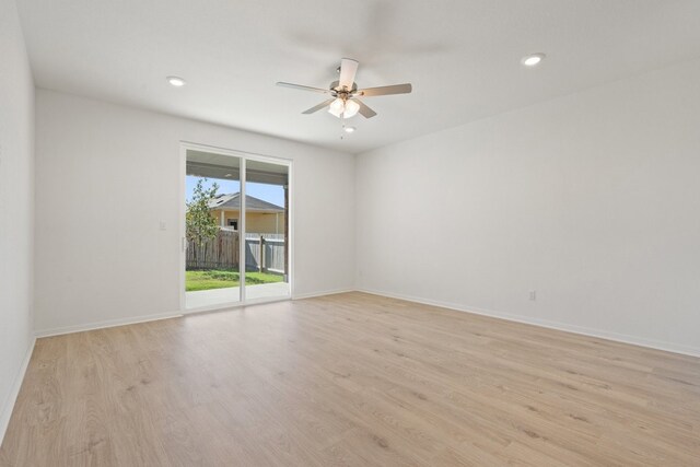 empty room with light hardwood / wood-style flooring and ceiling fan