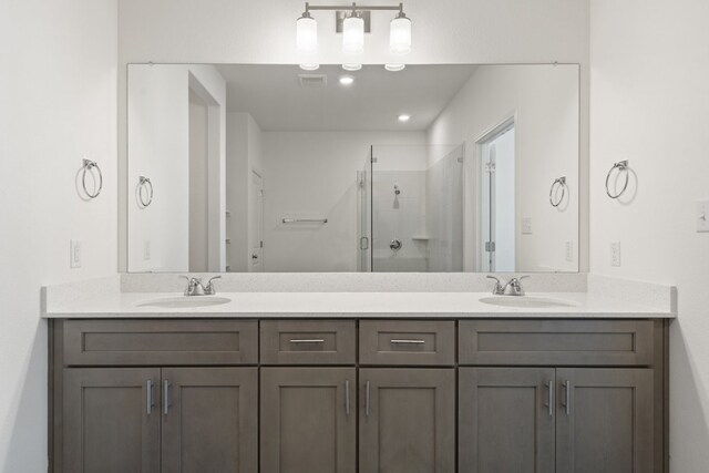 bathroom featuring vanity and an enclosed shower