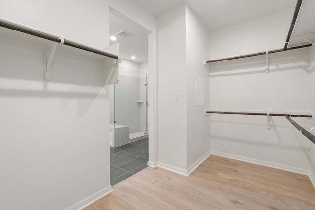 spacious closet with hardwood / wood-style floors