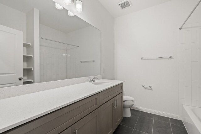 full bathroom with vanity, tiled shower / bath combo, toilet, and tile patterned flooring