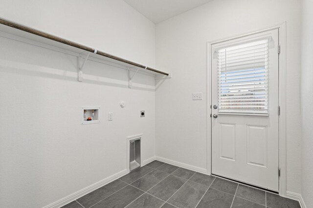 clothes washing area featuring hookup for a washing machine, hookup for an electric dryer, gas dryer hookup, and dark tile patterned flooring