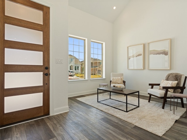 interior space with vaulted ceiling and dark hardwood / wood-style floors