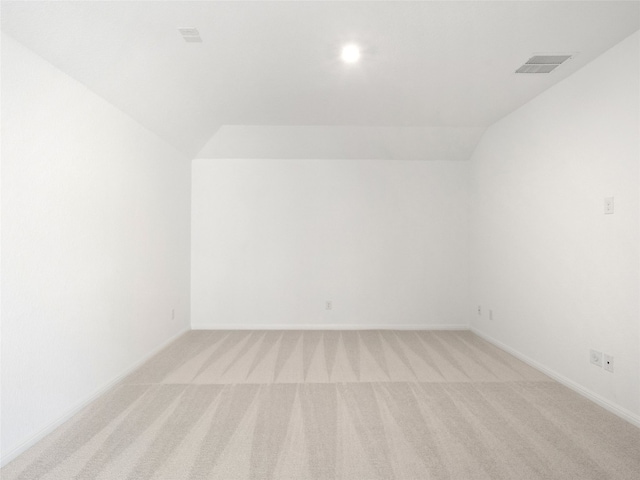 bonus room featuring vaulted ceiling and light colored carpet