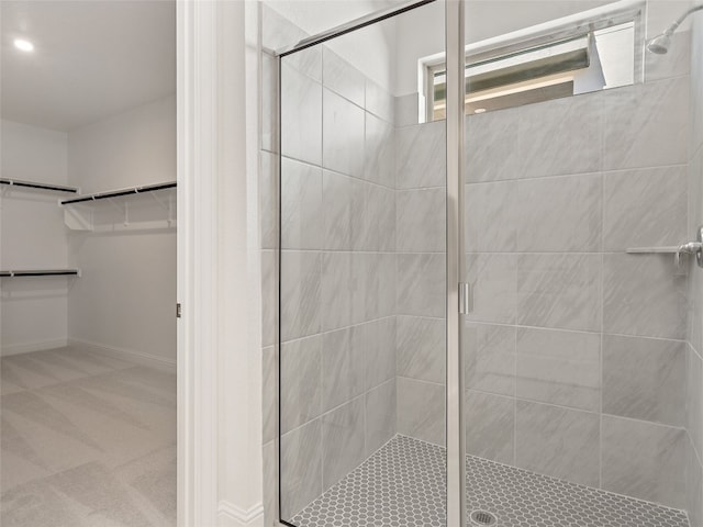 bathroom with a shower with door