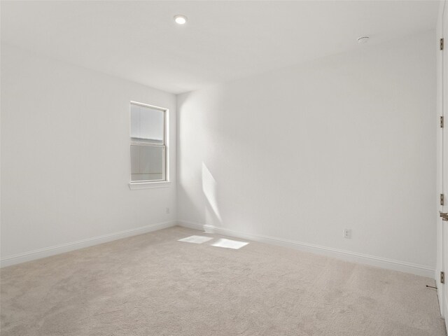 empty room featuring light carpet