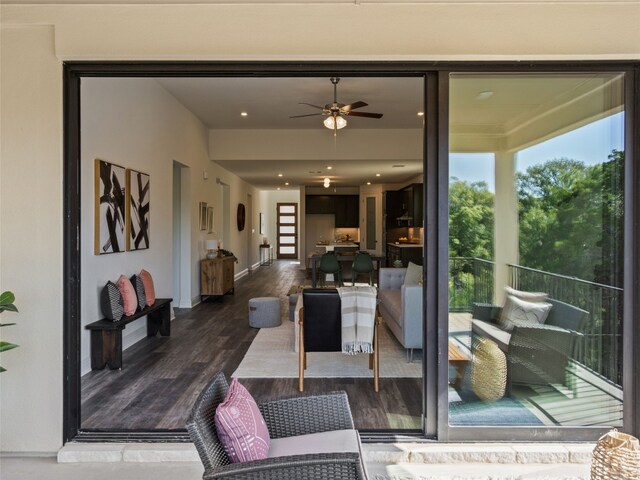 living room featuring ceiling fan and wood-type flooring