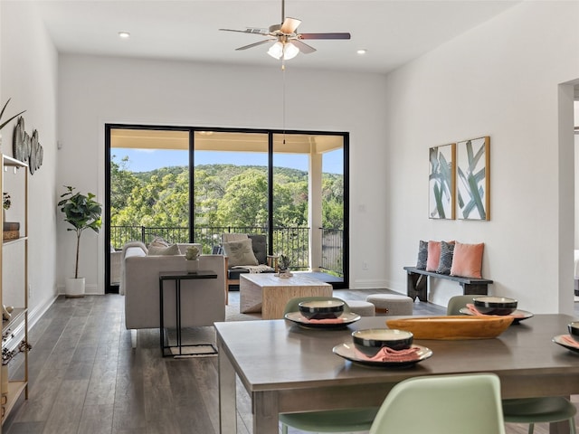 dining space featuring ceiling fan, dark wood-type flooring, and a healthy amount of sunlight