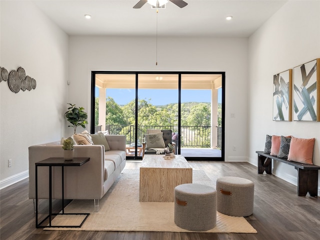 living room featuring ceiling fan and wood-type flooring