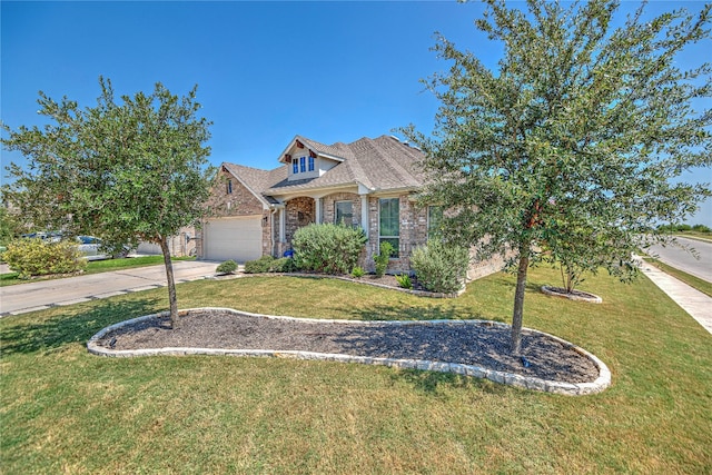 view of front of property with a garage and a front yard