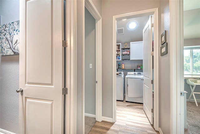 hall featuring light hardwood / wood-style flooring and washing machine and dryer