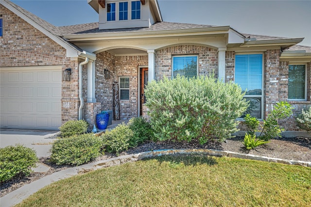 entrance to property with a yard and a garage