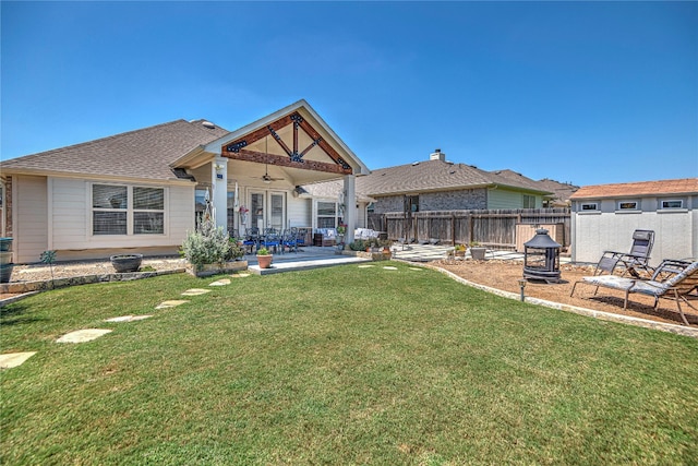 exterior space with ceiling fan, a yard, and a patio