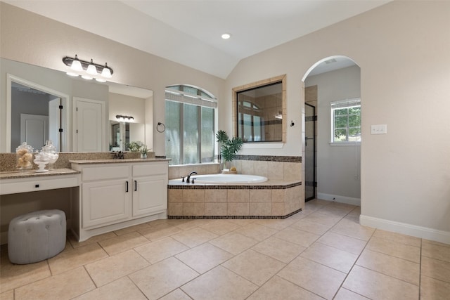 bathroom featuring plus walk in shower, vaulted ceiling, vanity, and tile patterned floors