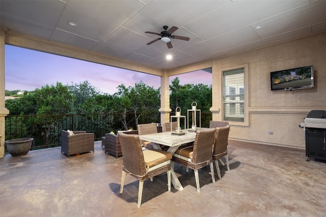 patio terrace at dusk featuring ceiling fan