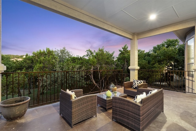 patio terrace at dusk featuring an outdoor hangout area