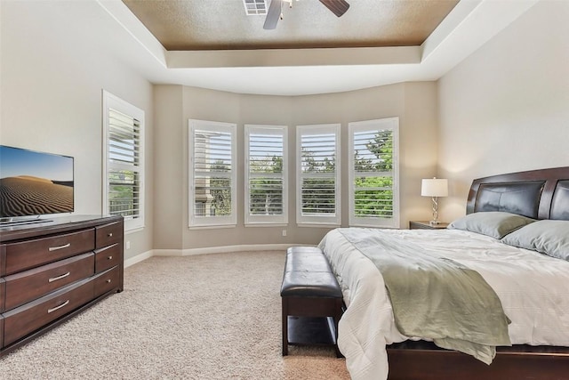 1104 Lions Lair, Leander, TX 78641 - bedroom featuring a tray ceiling, light colored carpet, and a ceiling fan