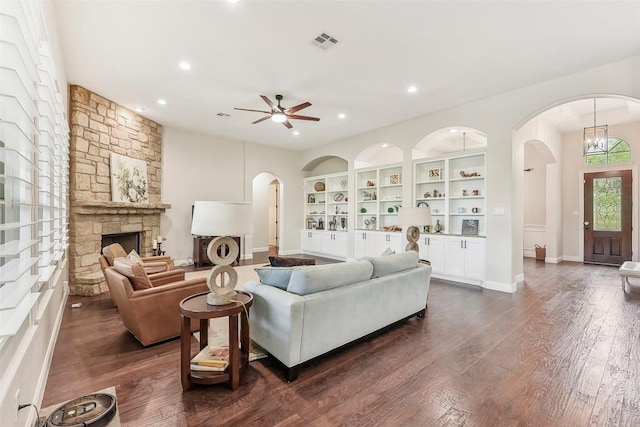 1104 Lions Lair, Leander, TX 78641 - living room featuring arched walkways, ceiling fan, recessed lighting, dark wood-type flooring, and a fireplace