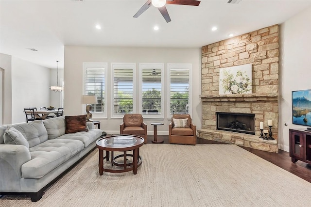 1104 Lions Lair, Leander, TX 78641 - living room with a fireplace, a ceiling fan, wood finished floors, and recessed lighting