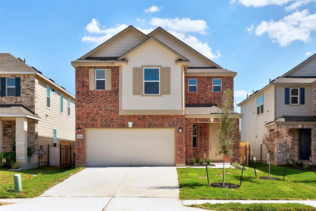 view of front of house with a front yard and a garage