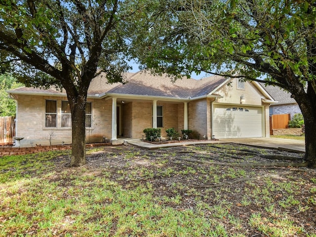 ranch-style house with covered porch and a garage