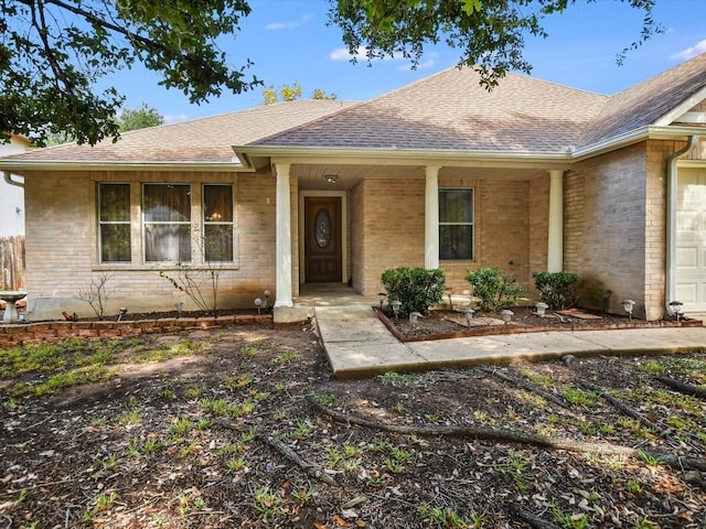 905 E Olympic Dr, Pflugerville, TX 78660 - property entrance featuring roof with shingles and brick siding