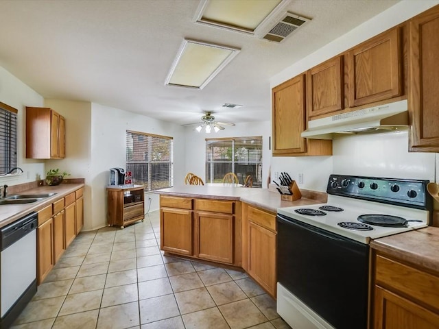 905 E Olympic Dr, Pflugerville, TX 78660 - kitchen featuring range with electric stovetop, under cabinet range hood, dishwasher, a peninsula, and light tile patterned floors