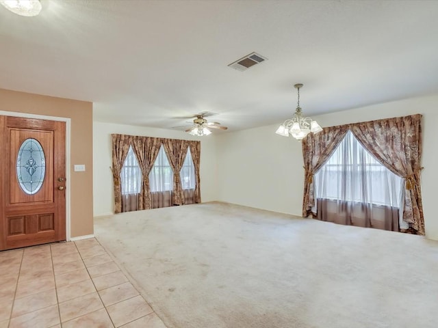 905 E Olympic Dr, Pflugerville, TX 78660 - foyer featuring a chandelier, light colored carpet, a ceiling fan, and light tile patterned floors