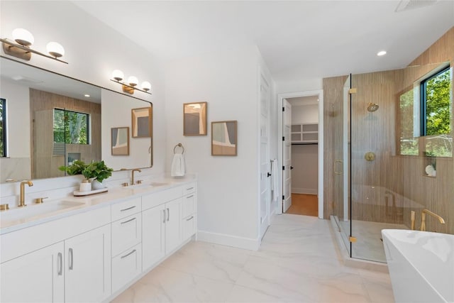 2109 Wordsworth Dr Unit 1, Austin, TX 78704 - full bath featuring a shower stall, double vanity, a freestanding bath, a walk in closet, and marble finish floors