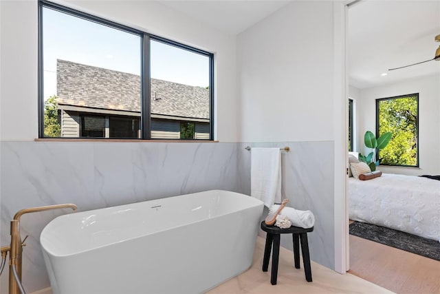 2109 Wordsworth Dr Unit 1, Austin, TX 78704 - bathroom with connected bathroom, a soaking tub, tile walls, and wainscoting