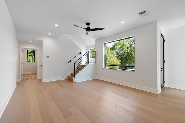 2109 Wordsworth Dr Unit 1, Austin, TX 78704 - unfurnished living room with healthy amount of natural light, light wood finished floors, stairway, ceiling fan, and recessed lighting