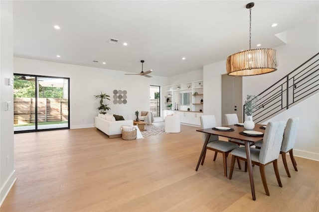2109 Wordsworth Dr Unit 1, Austin, TX 78704 - dining room with light wood-type flooring, a chandelier, stairs, a ceiling fan, and recessed lighting