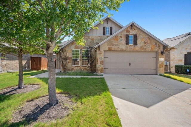 view of front of property featuring a garage and a front yard