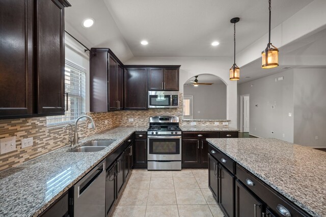 kitchen featuring sink, stainless steel appliances, ceiling fan, and backsplash