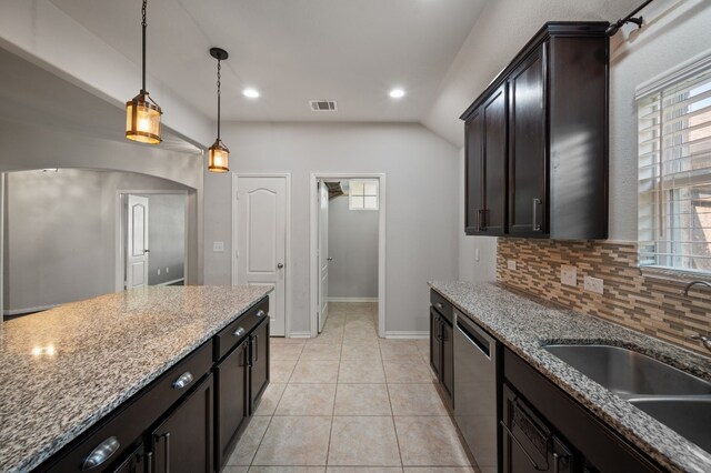 kitchen with dishwasher, decorative backsplash, light tile patterned floors, and a healthy amount of sunlight