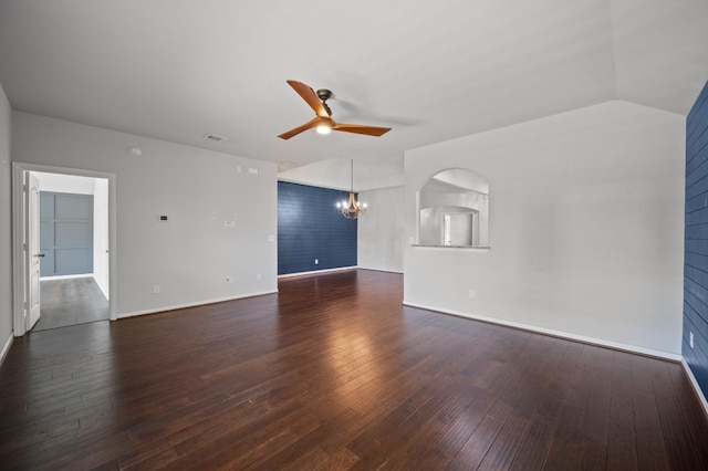 spare room with ceiling fan with notable chandelier, hardwood / wood-style flooring, and lofted ceiling