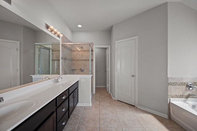 bathroom featuring tile patterned flooring, independent shower and bath, and vanity