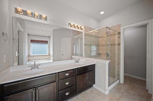 bathroom featuring tile patterned flooring, independent shower and bath, and vanity