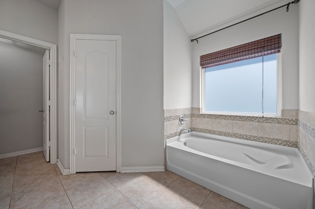 bathroom with a bathing tub and tile patterned floors