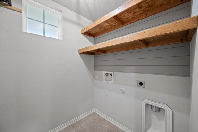 laundry area with hookup for an electric dryer, light tile patterned flooring, hookup for a washing machine, and hookup for a gas dryer