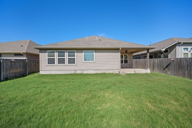 rear view of house featuring a patio and a yard