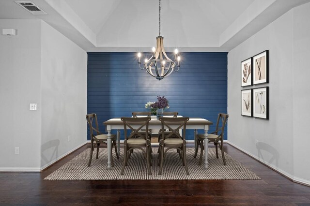 dining room featuring hardwood / wood-style floors and an inviting chandelier