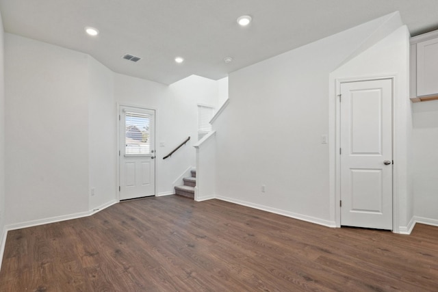 unfurnished living room featuring dark hardwood / wood-style floors