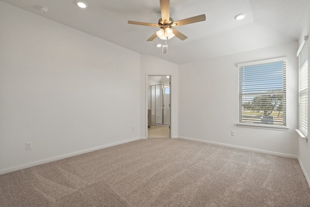 carpeted spare room featuring ceiling fan and lofted ceiling