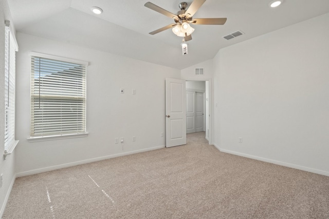 unfurnished bedroom with ceiling fan, light colored carpet, and vaulted ceiling