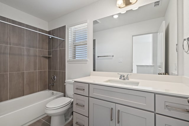 full bathroom with vanity, toilet, and tiled shower / bath