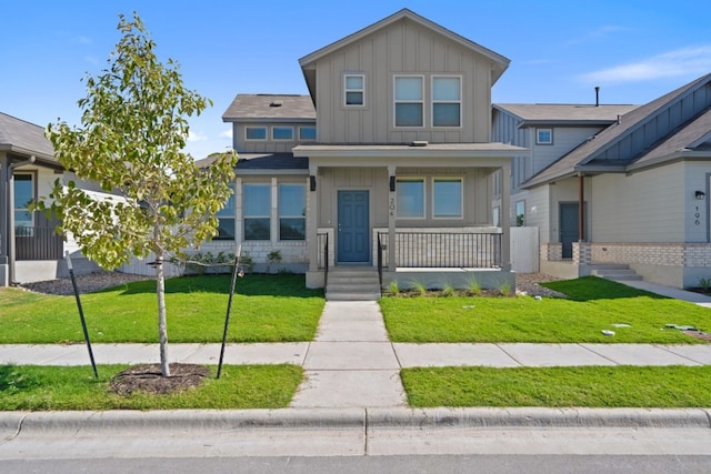 craftsman inspired home featuring a porch and a front lawn