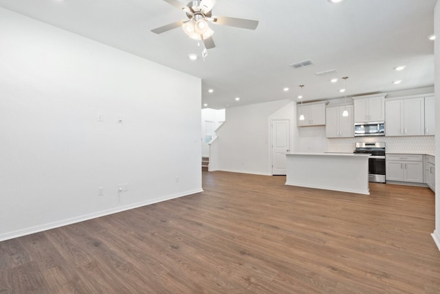 unfurnished living room featuring ceiling fan and light hardwood / wood-style flooring