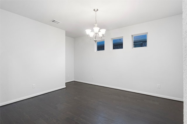 unfurnished room featuring a chandelier and hardwood / wood-style flooring