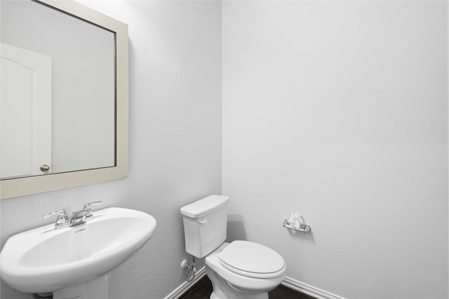 bathroom featuring sink and toilet